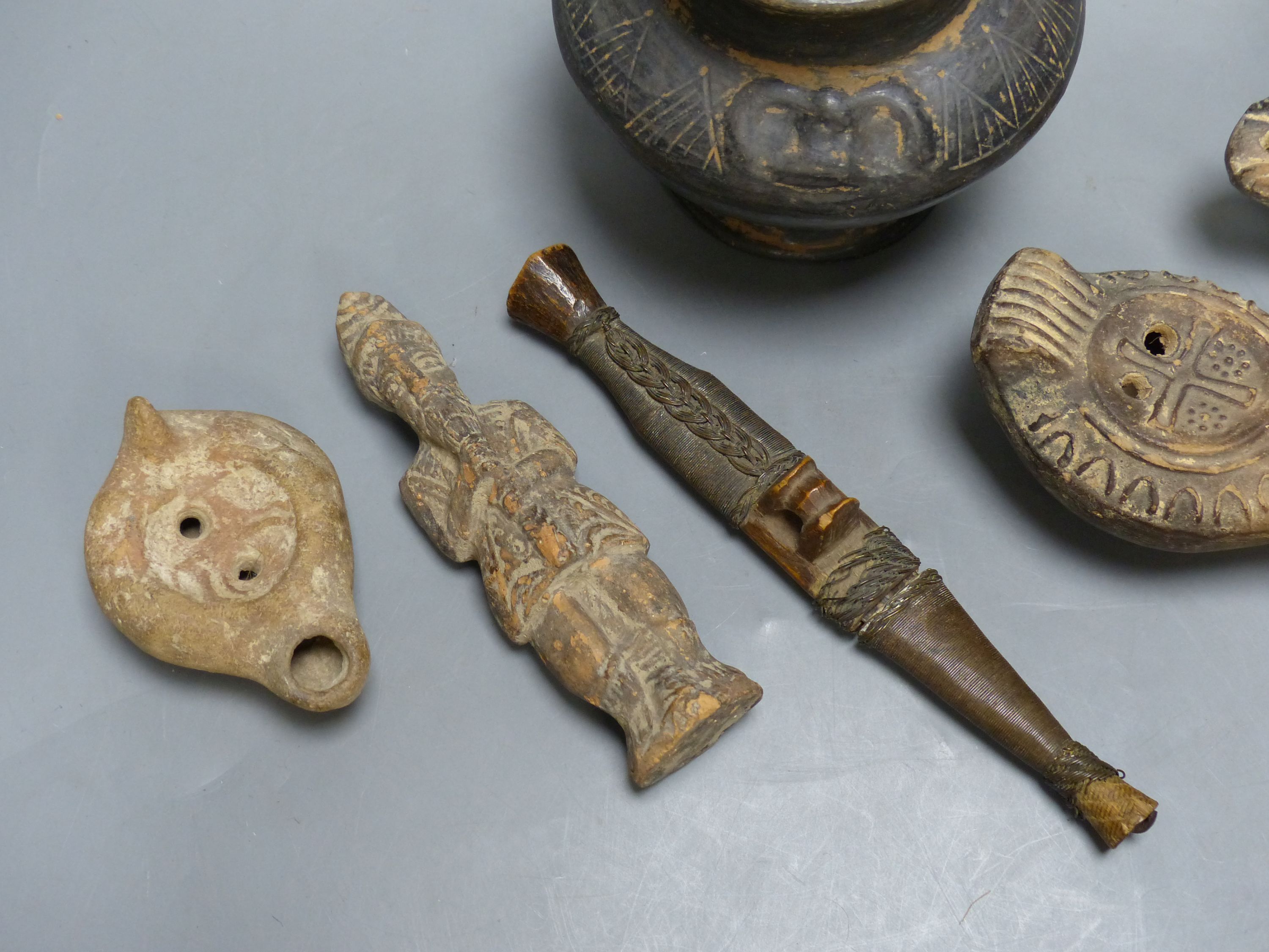 A group of antiquities, three oil lamps, a vase and a figure, etc.